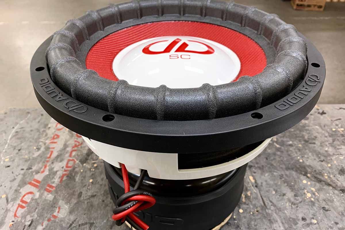 USA Made subwoofer with white powder coat basket, red cone, white epoxy dust cap with red DDA logo and super charged decal