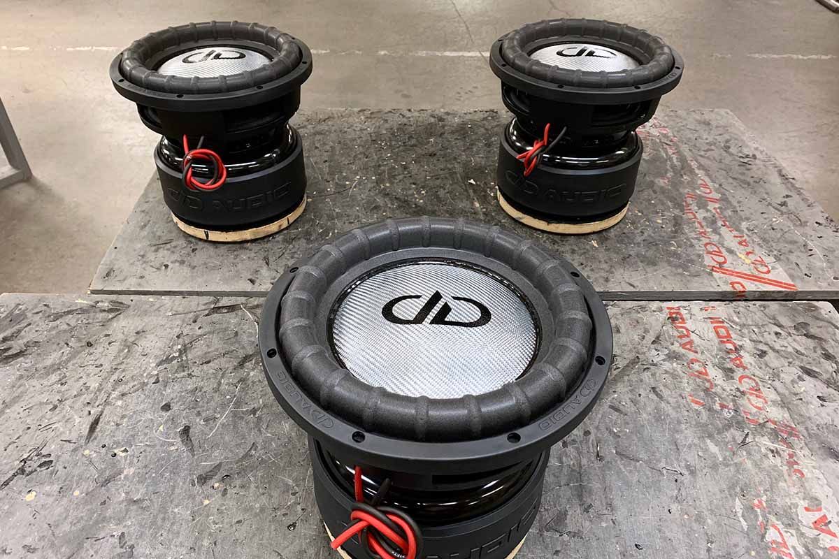 Three USA Made subwoofers with silver dust caps, black DDA logos