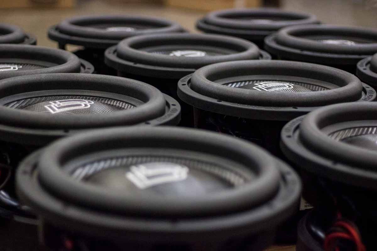Twelve USA Made Subwoofers with black cones, black dust caps, white DD Classic logos