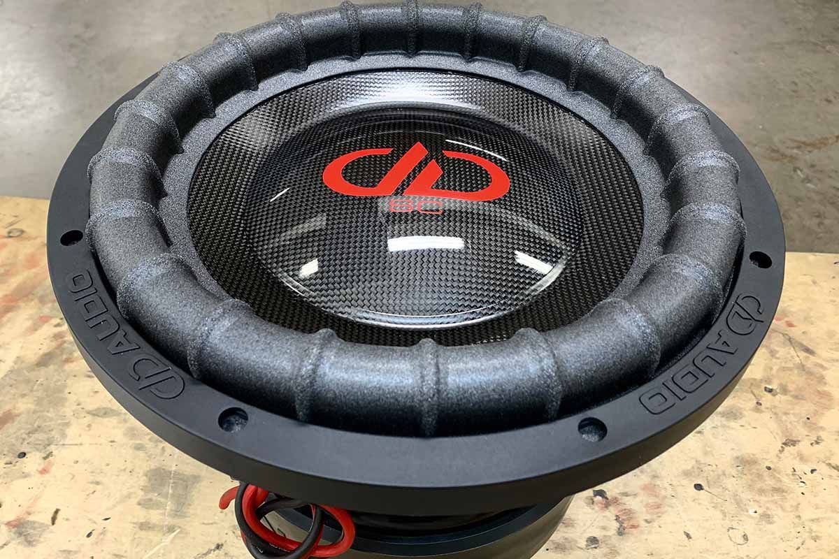 USA Made subwoofer with black cone, high gloss black dust cap, red DDA logo and red super charged decal