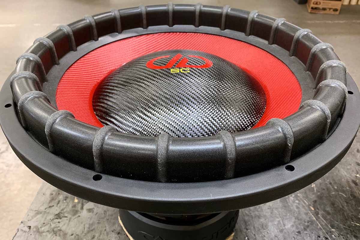 USA Made subwoofer with red cone, black carbon fiber dust cap, red DDA logo and yellow super charged decal