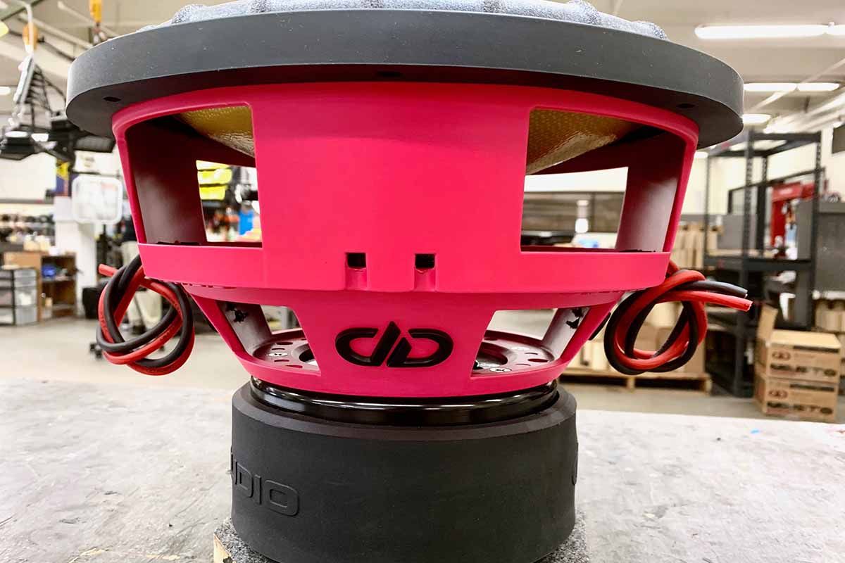 USA Made subwoofer with pink powder coat basket featuring black DDA logo embossing