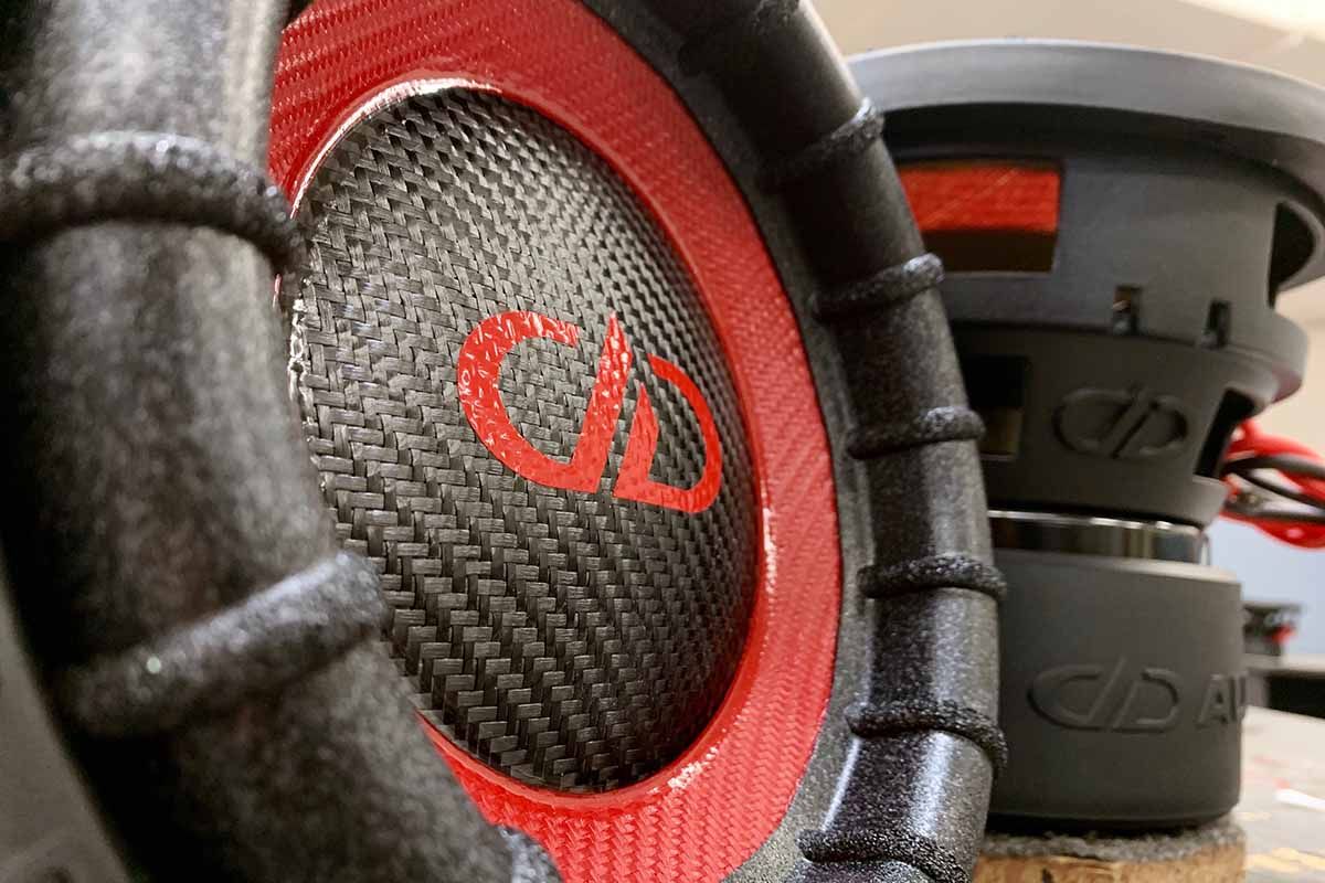 Two USA made subwoofers with red carbon fiber cones, black carbon fiber dust caps and red DDA logos