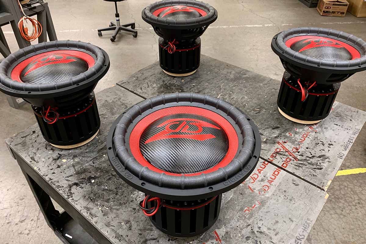 Four USA Made subwoofers with red cones, black carbon fiber dust caps and red DD Z logos