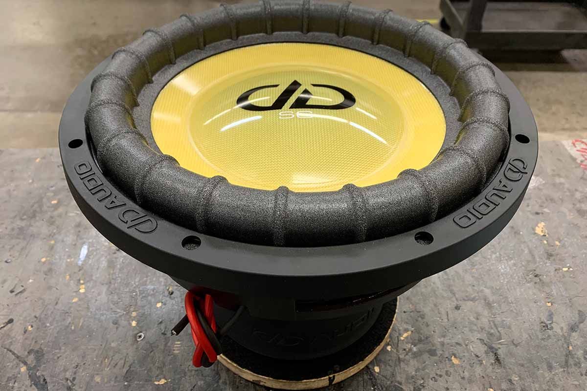 USA Made Subwoofer with high gloss yellow dust cap, yellow cone, black DDA logo and white Super Charged decal.