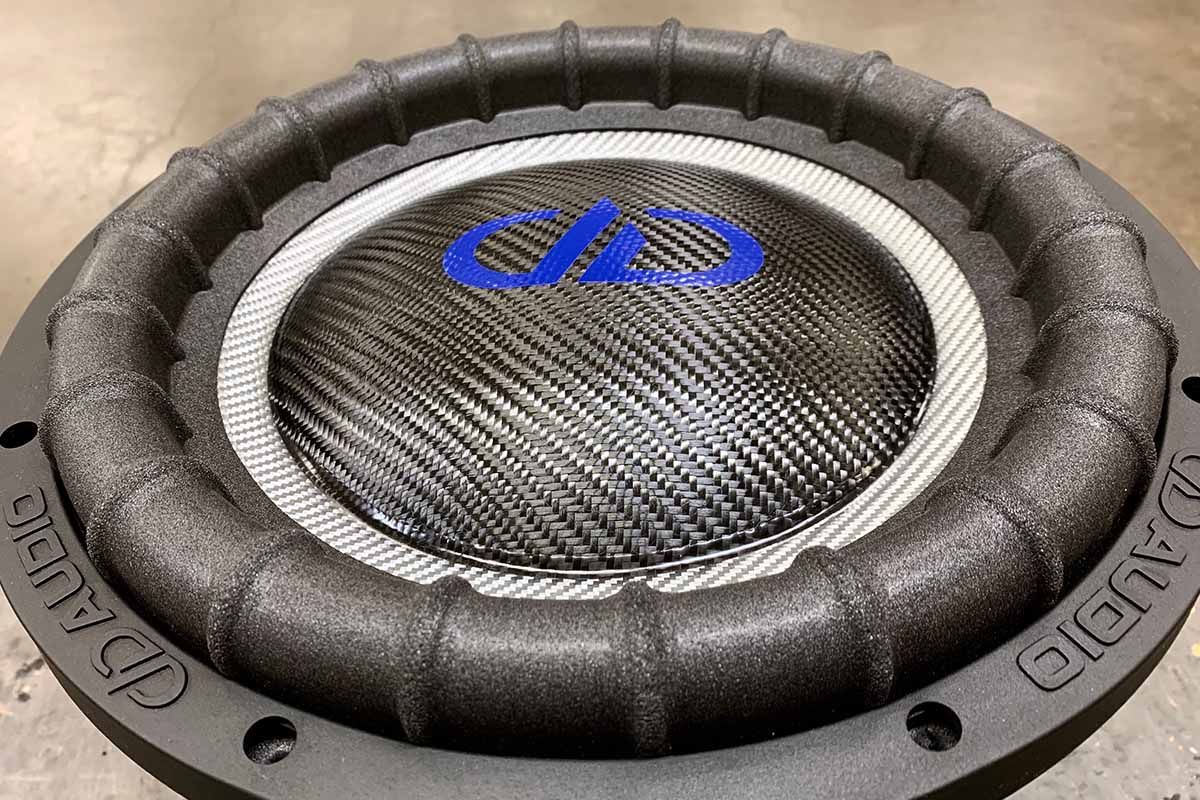 USA Made subwoofer with black carbon fiber dust cap on silver carbon cone with blue DDA logo