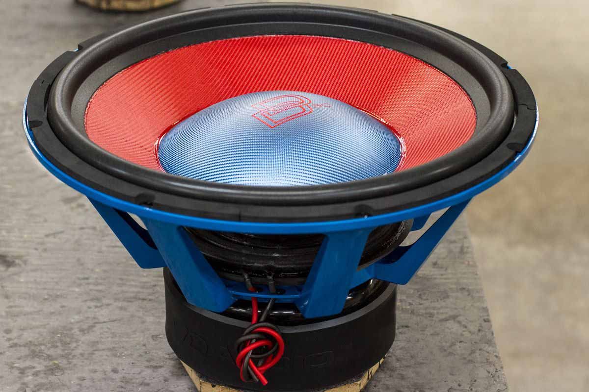 Large USA Made Subwoofer with electric blue powder coat basket, red cone, blue dust cap, red DD Classic logo, and red Super Charged decal