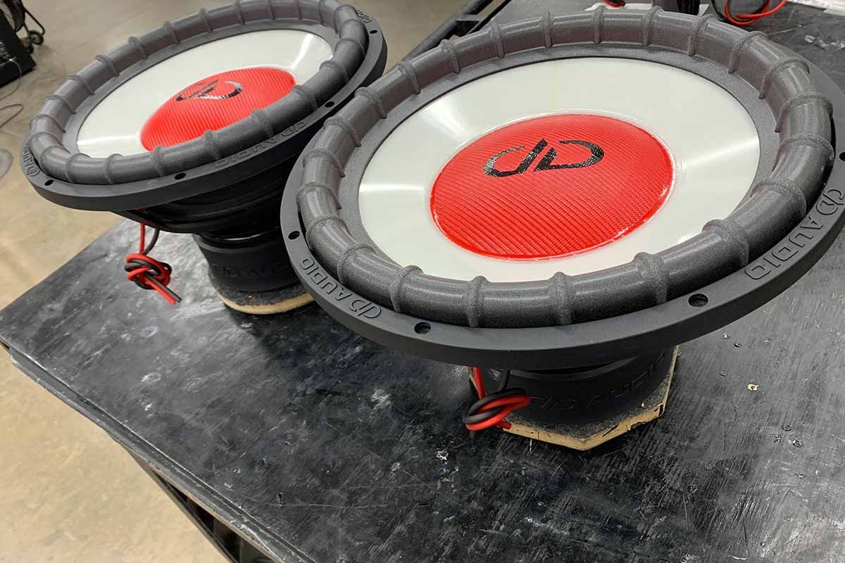 Two USA Made Subwoofers with ghost cones with red dust caps and black DDA logos