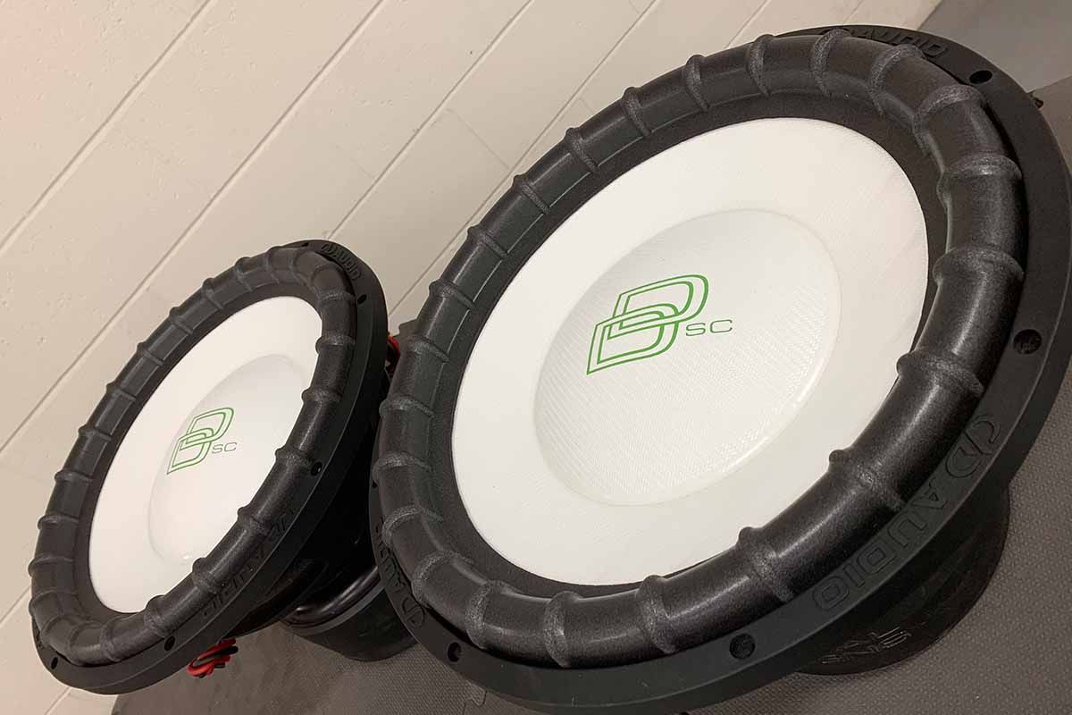 Two USA Made Subwoofers with white cones, white dust caps, green DD Classic Logos and green Super Charged decals