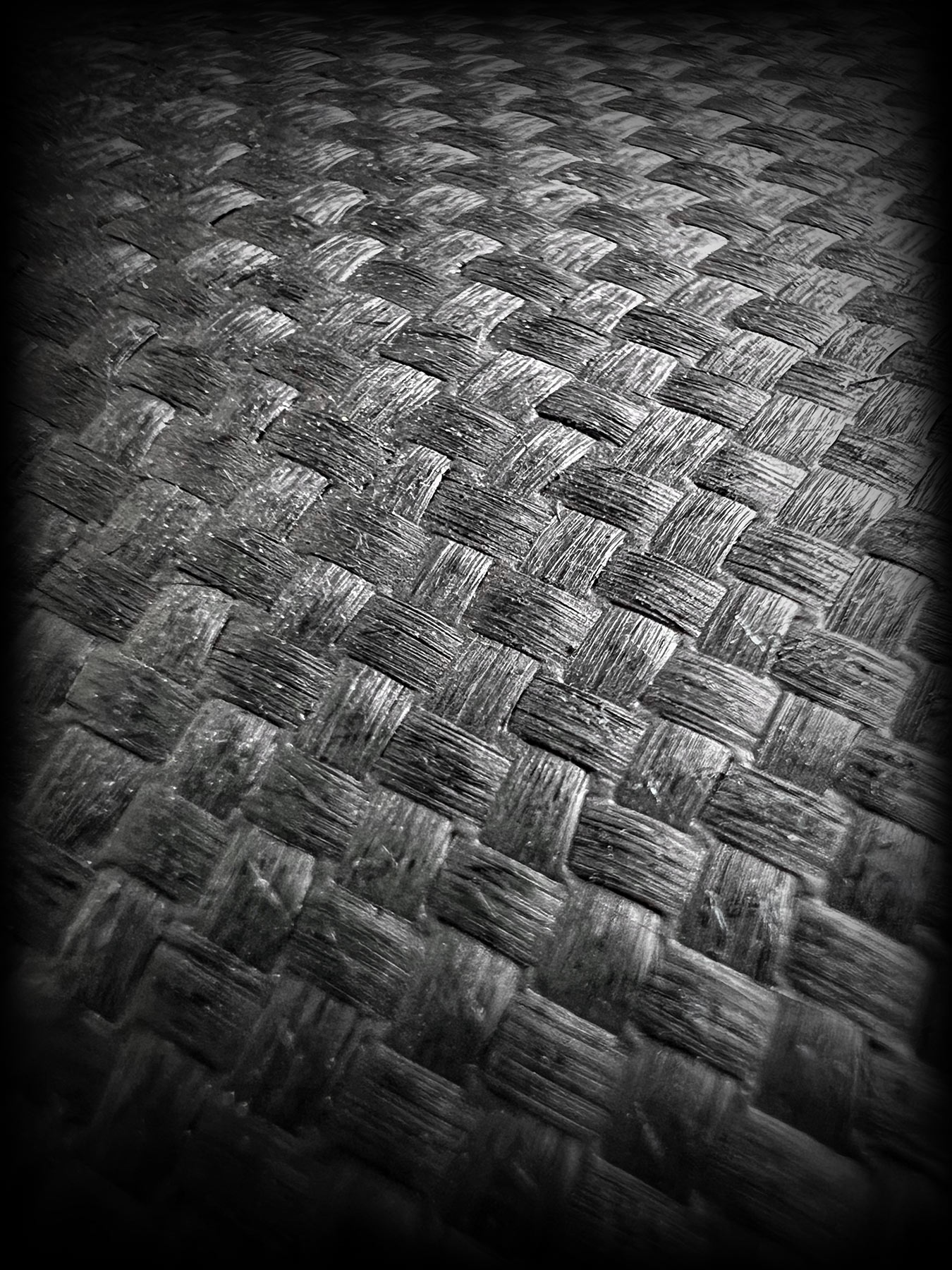 Stylized close up of carbon fiber weave